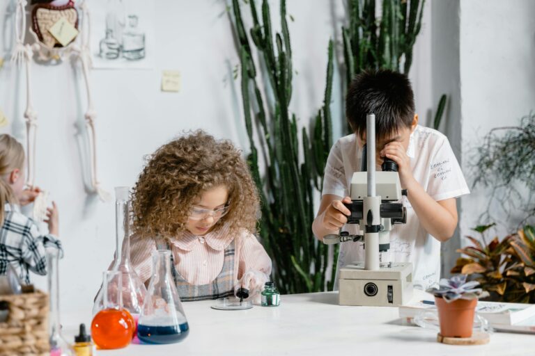 Kids exploring science concepts using a microscope and lab tools, fostering education and curiosity.